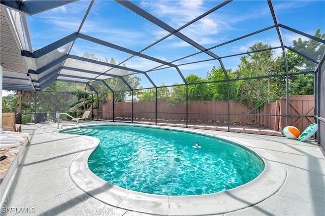 view of pool featuring a lanai and a patio