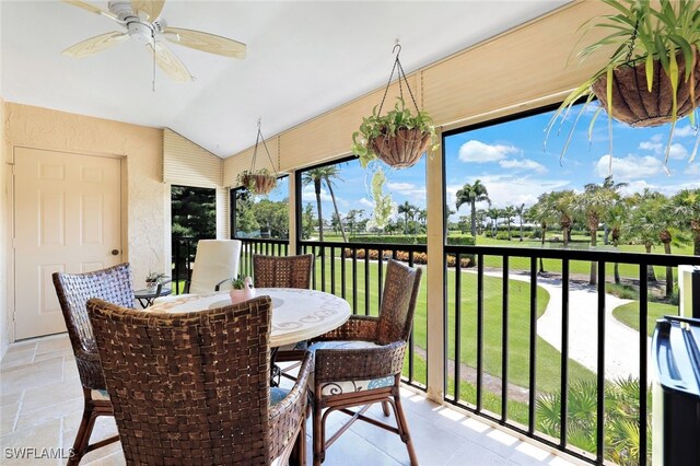 sunroom / solarium featuring ceiling fan and vaulted ceiling