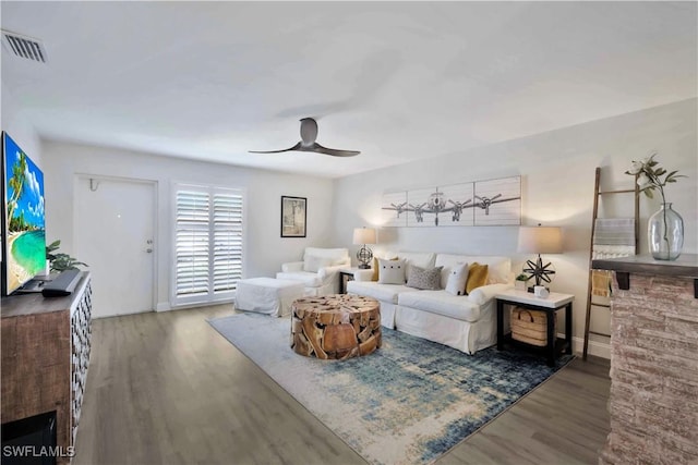 living room featuring visible vents, wood finished floors, and ceiling fan