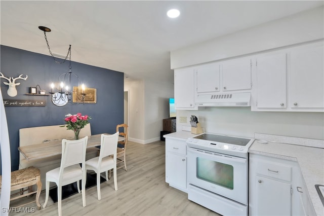 kitchen with white electric range oven, hanging light fixtures, white cabinetry, light hardwood / wood-style floors, and an inviting chandelier