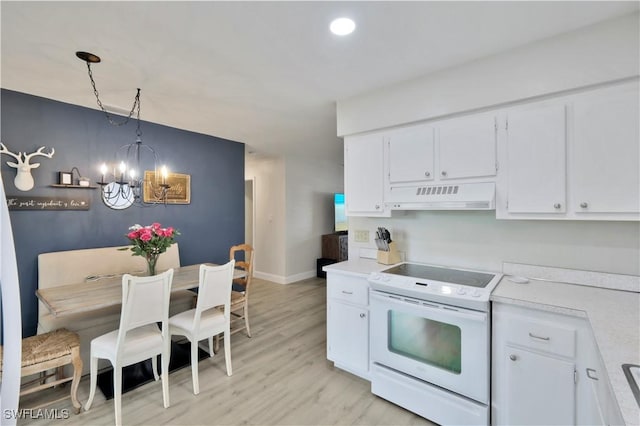 kitchen with under cabinet range hood, an inviting chandelier, white cabinetry, light countertops, and white range with electric stovetop