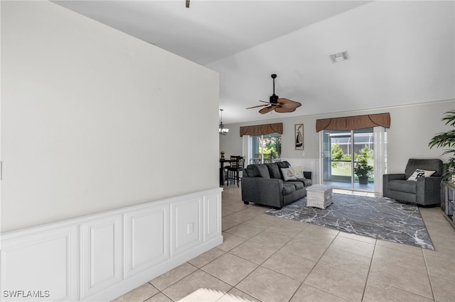 living room featuring vaulted ceiling, ceiling fan, and light tile patterned flooring