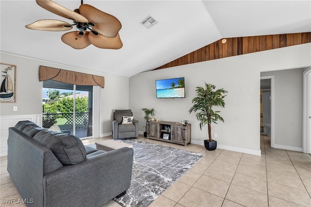 tiled living room with ceiling fan and vaulted ceiling