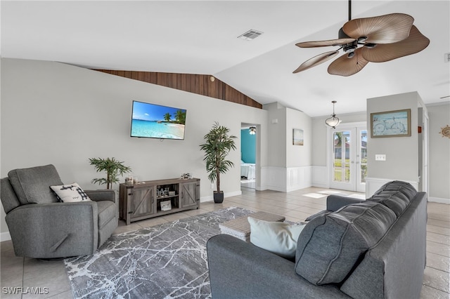 living room featuring tile patterned flooring, ceiling fan, and vaulted ceiling