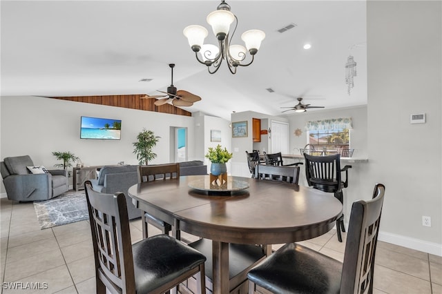 dining area with vaulted ceiling, light tile patterned floors, and ceiling fan with notable chandelier