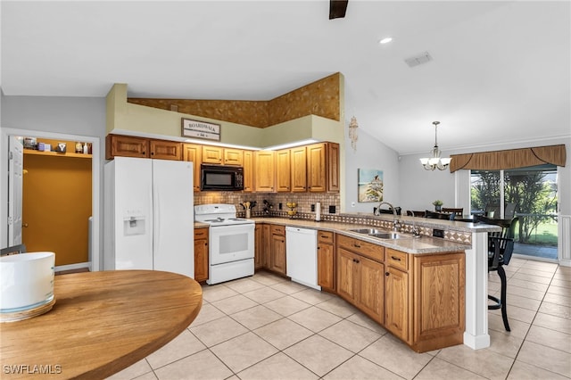 kitchen featuring sink, hanging light fixtures, kitchen peninsula, vaulted ceiling, and white appliances