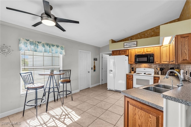 kitchen featuring ceiling fan, sink, lofted ceiling, white appliances, and light tile patterned flooring