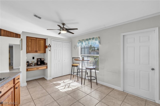 kitchen with ceiling fan and light tile patterned floors