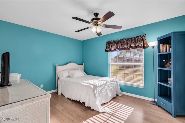 bedroom with hardwood / wood-style floors and ceiling fan