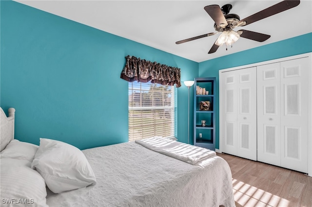 bedroom featuring a closet, light hardwood / wood-style flooring, and ceiling fan