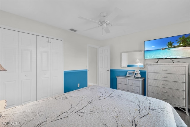 bedroom with hardwood / wood-style floors, a closet, and ceiling fan