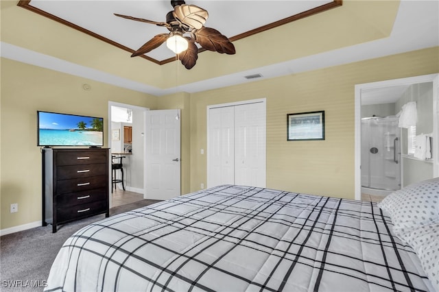 carpeted bedroom featuring ensuite bath, ceiling fan, a closet, and ornamental molding