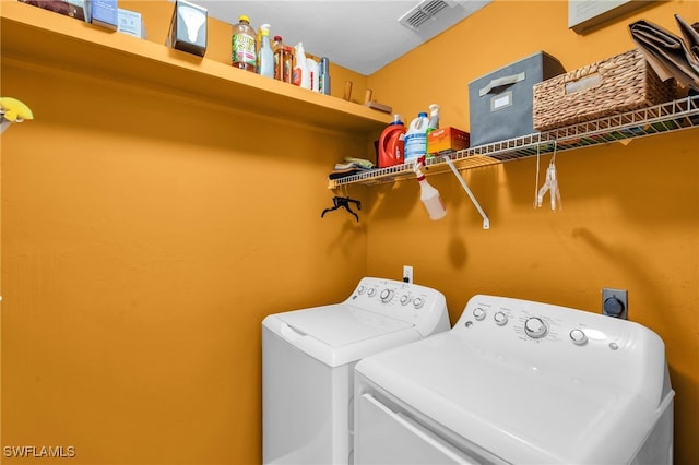 washroom with washing machine and clothes dryer