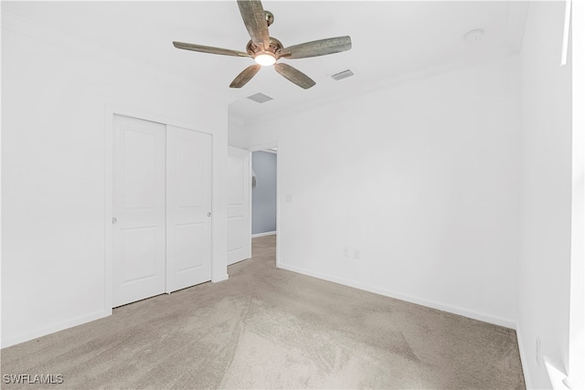 unfurnished bedroom featuring light carpet, a closet, and ceiling fan