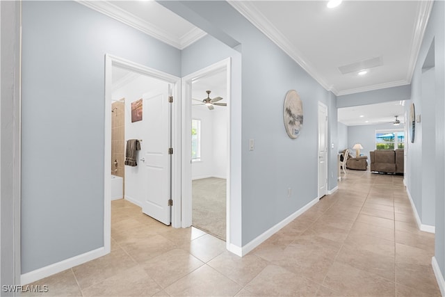 hall featuring crown molding and light tile patterned floors