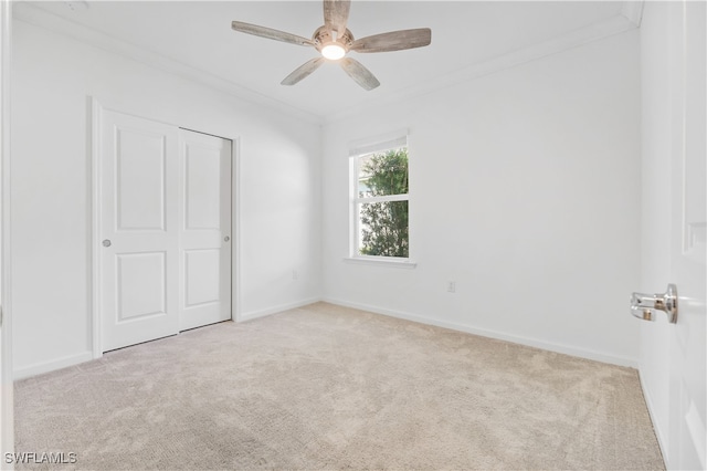 unfurnished bedroom featuring light carpet, a closet, and ceiling fan