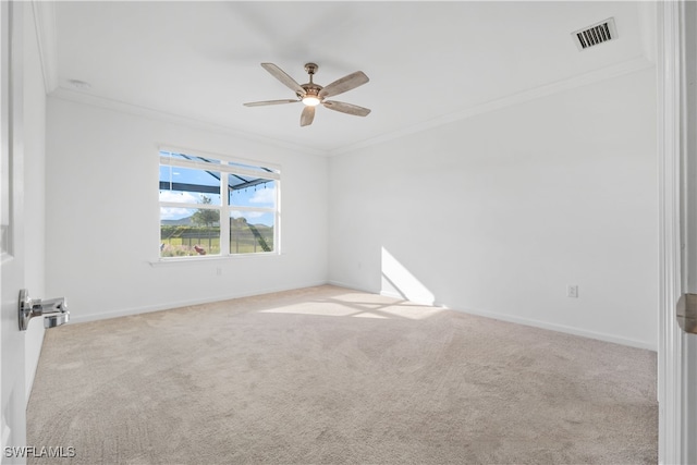 carpeted empty room with crown molding and ceiling fan