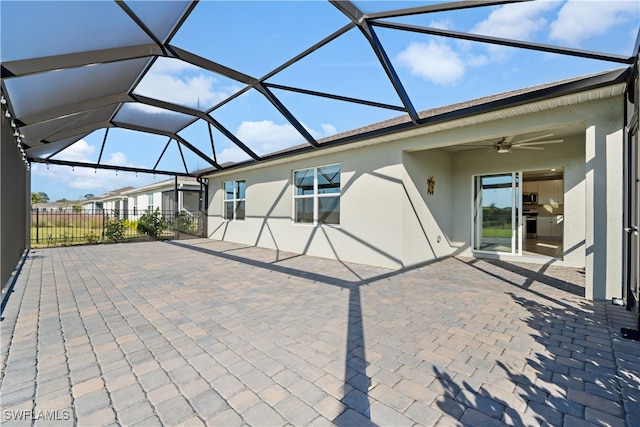 view of patio / terrace featuring ceiling fan and a lanai