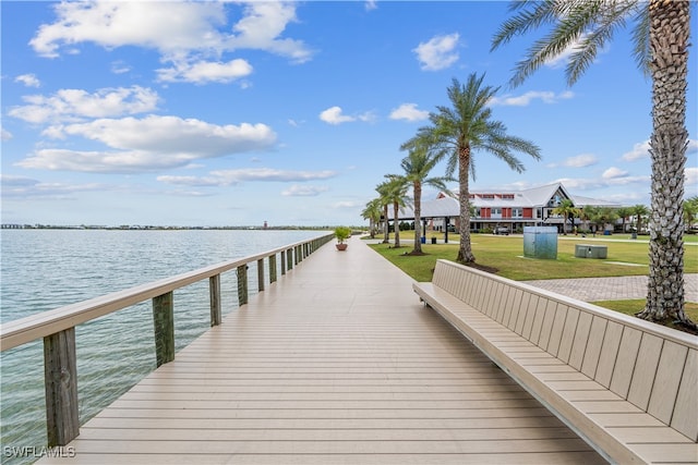 view of dock featuring a gazebo, a yard, and a water view