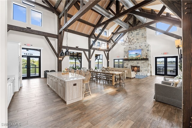 kitchen featuring french doors, high vaulted ceiling, and a kitchen island