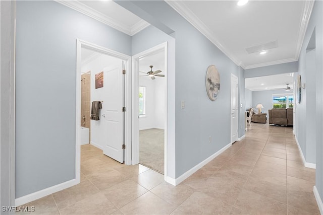 corridor with crown molding, a wealth of natural light, and light tile patterned floors