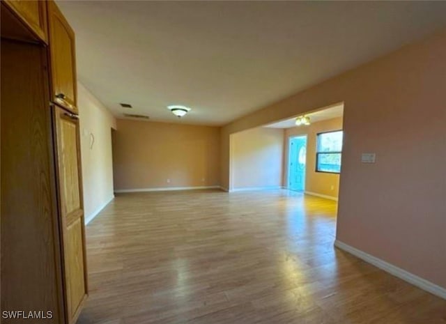 spare room with wood-type flooring