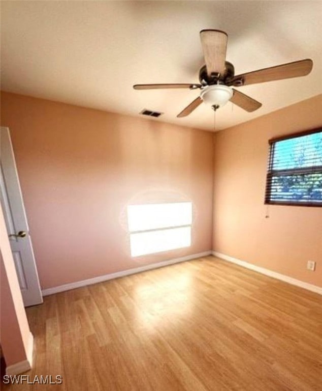 unfurnished room with ceiling fan and light hardwood / wood-style floors