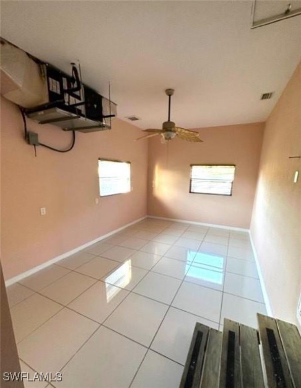 unfurnished room with ceiling fan and light tile patterned floors