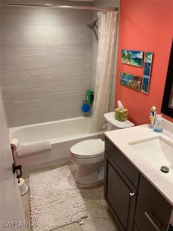 full bathroom with vanity, toilet, and shower / tub combo with curtain