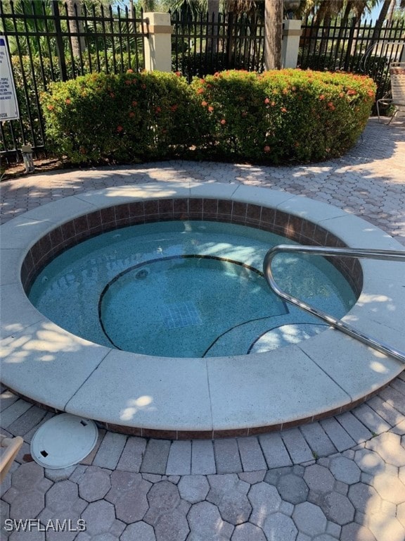 view of swimming pool with a community hot tub