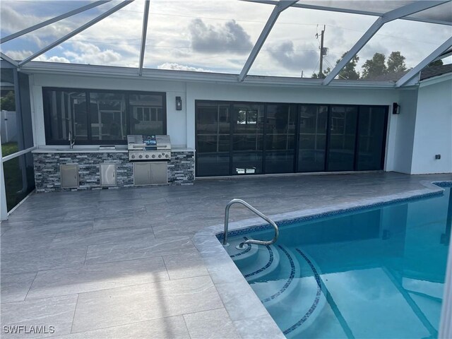 view of swimming pool with a patio area, a grill, and a lanai