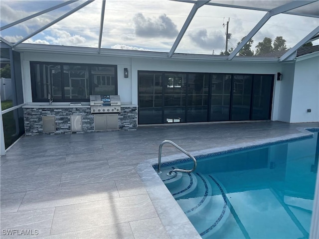 pool with glass enclosure, a grill, area for grilling, and a patio