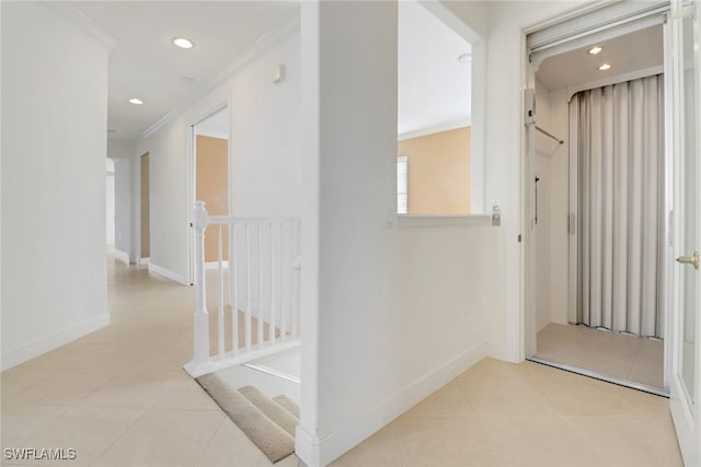 hall with crown molding and light tile patterned flooring