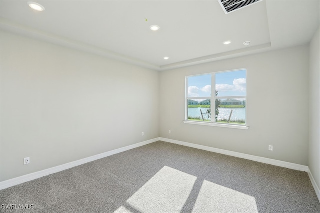 carpeted spare room with a water view