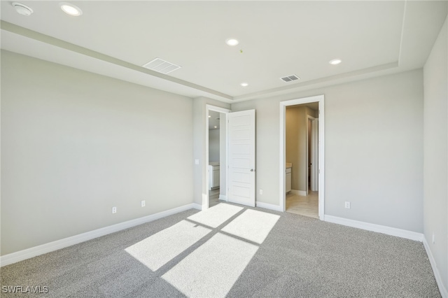 unfurnished room featuring light colored carpet