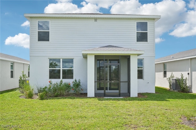 rear view of house with a yard