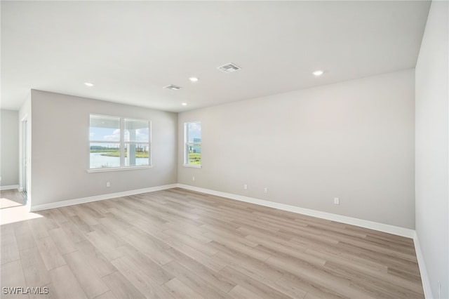 spare room with light wood-type flooring