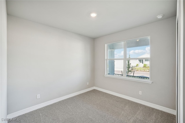 unfurnished room featuring carpet flooring