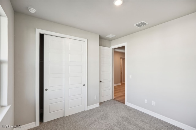 unfurnished bedroom featuring a closet and carpet