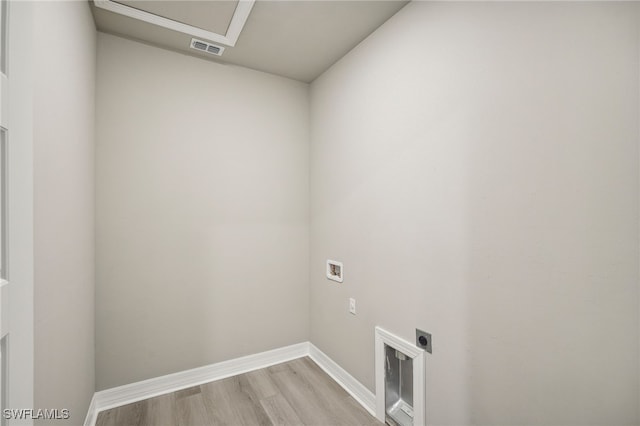 clothes washing area featuring hookup for a washing machine, light hardwood / wood-style floors, and hookup for an electric dryer