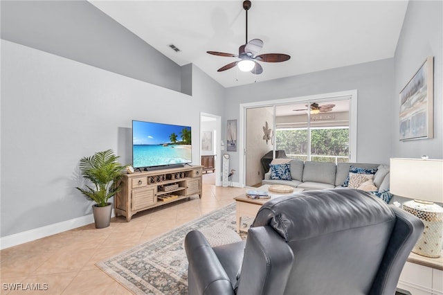 tiled living room featuring ceiling fan and vaulted ceiling