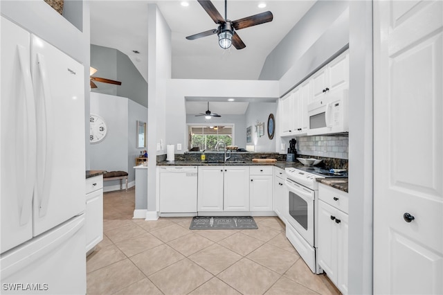 kitchen with light tile patterned floors, white appliances, and white cabinetry