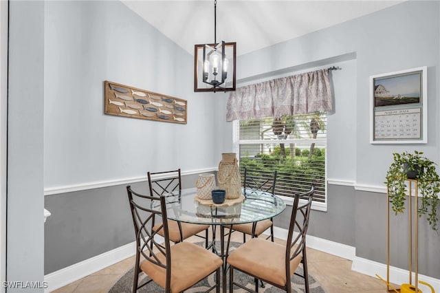 tiled dining room featuring a notable chandelier