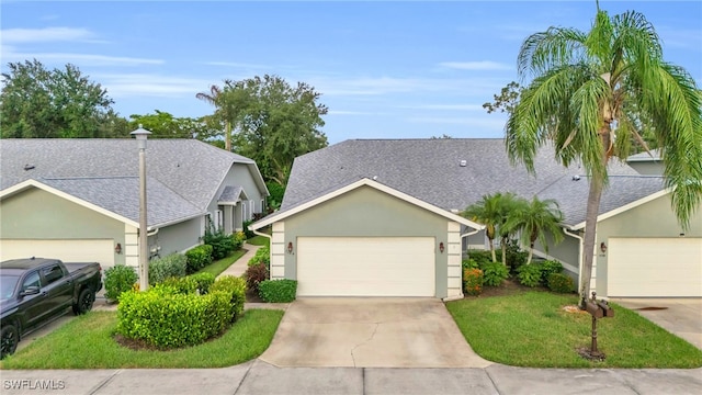 ranch-style house featuring a front lawn and a garage