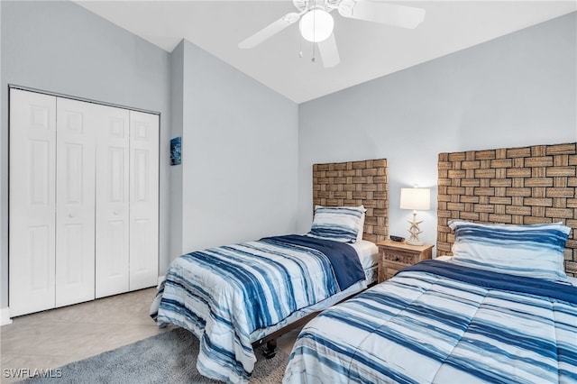 bedroom featuring vaulted ceiling, a closet, tile patterned flooring, and ceiling fan