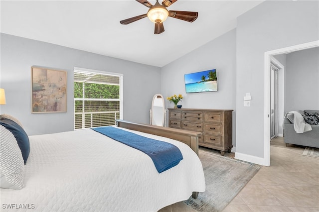 bedroom with ceiling fan, light tile patterned floors, and vaulted ceiling