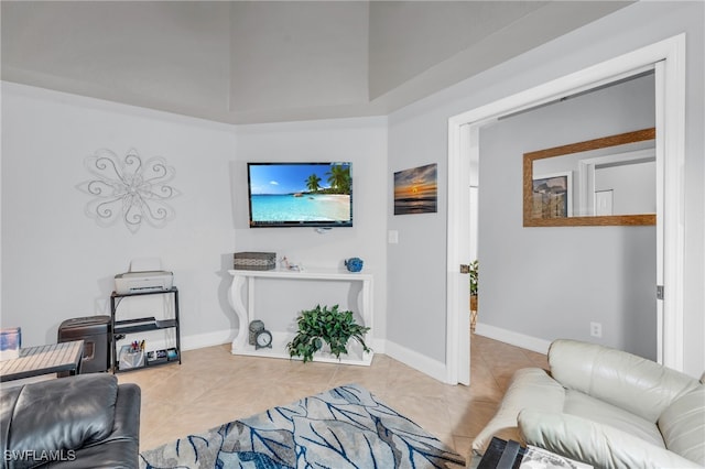 living room featuring tile patterned floors and a raised ceiling