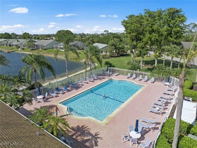 view of swimming pool featuring a water view and a patio