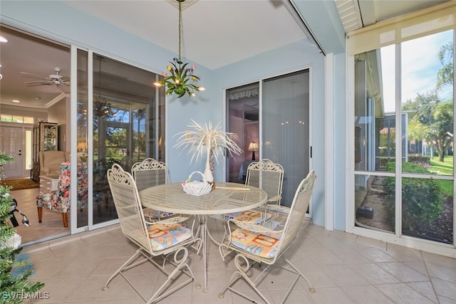 sunroom / solarium featuring plenty of natural light and ceiling fan