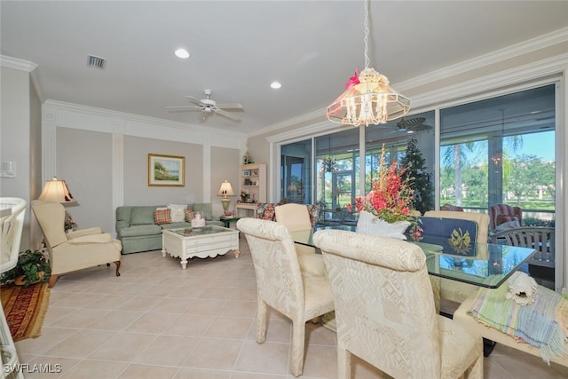 dining space with ceiling fan with notable chandelier, light tile patterned flooring, and ornamental molding